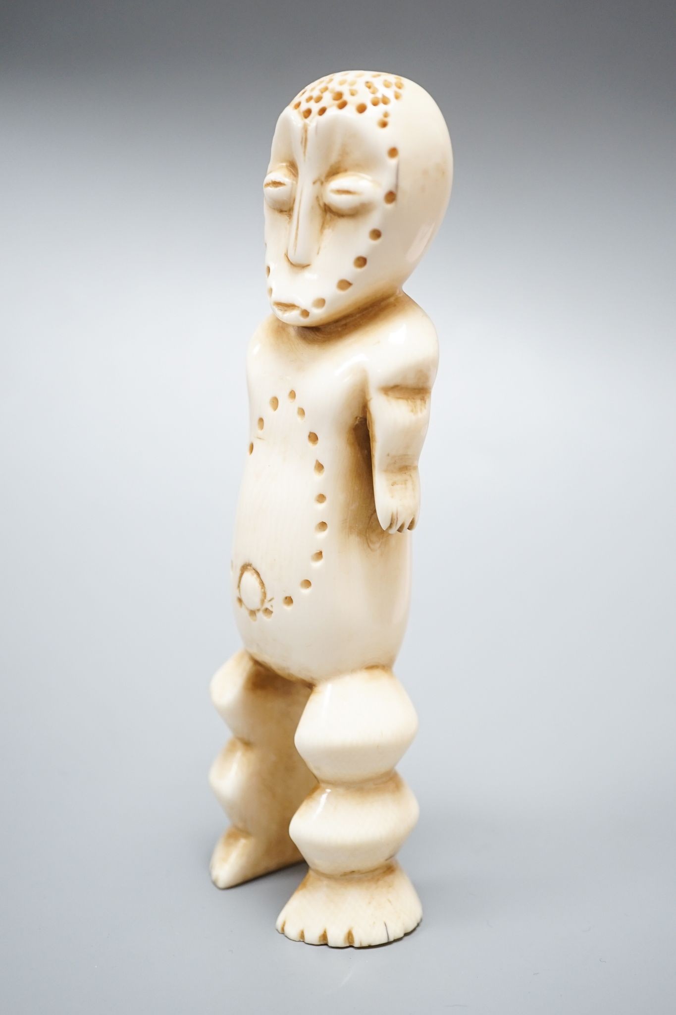 A Lega full-figured anthropomorphic sculpture of the short arm type, almond-shaped eyes. the stippling framing the concave face is common, a type made around 1920-1930, must be obtained shortly after creation., With its